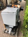 Kocioł CO retortowy z podajnikiem na węgiel groszek 14 kW. Widok z tyłu, na palecie.